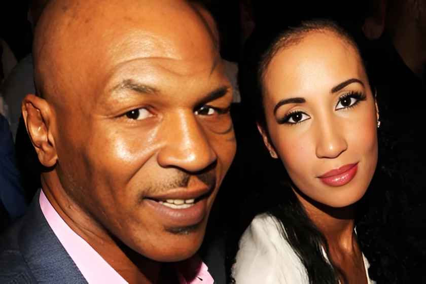 Mike Tyson posing with his wife at a public event